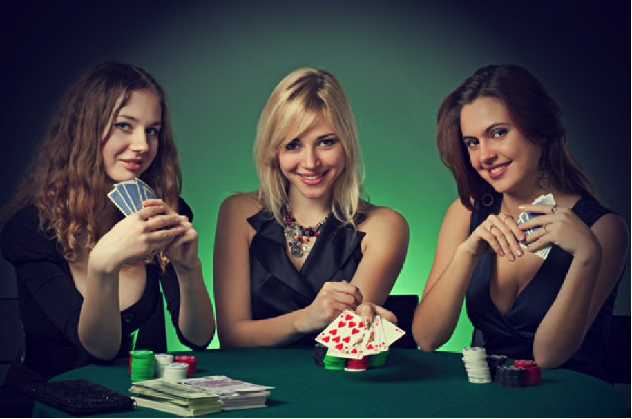 three pretty girls sitting at casino with poker cards