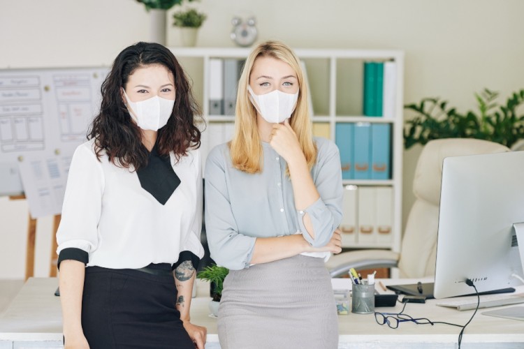 Women wearing masks at in a business office