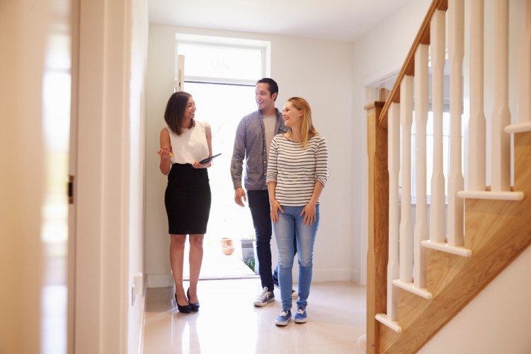 https://elements.envato.com/realtor-showing-young-couple-around-property-for-s-PRUUFP3
